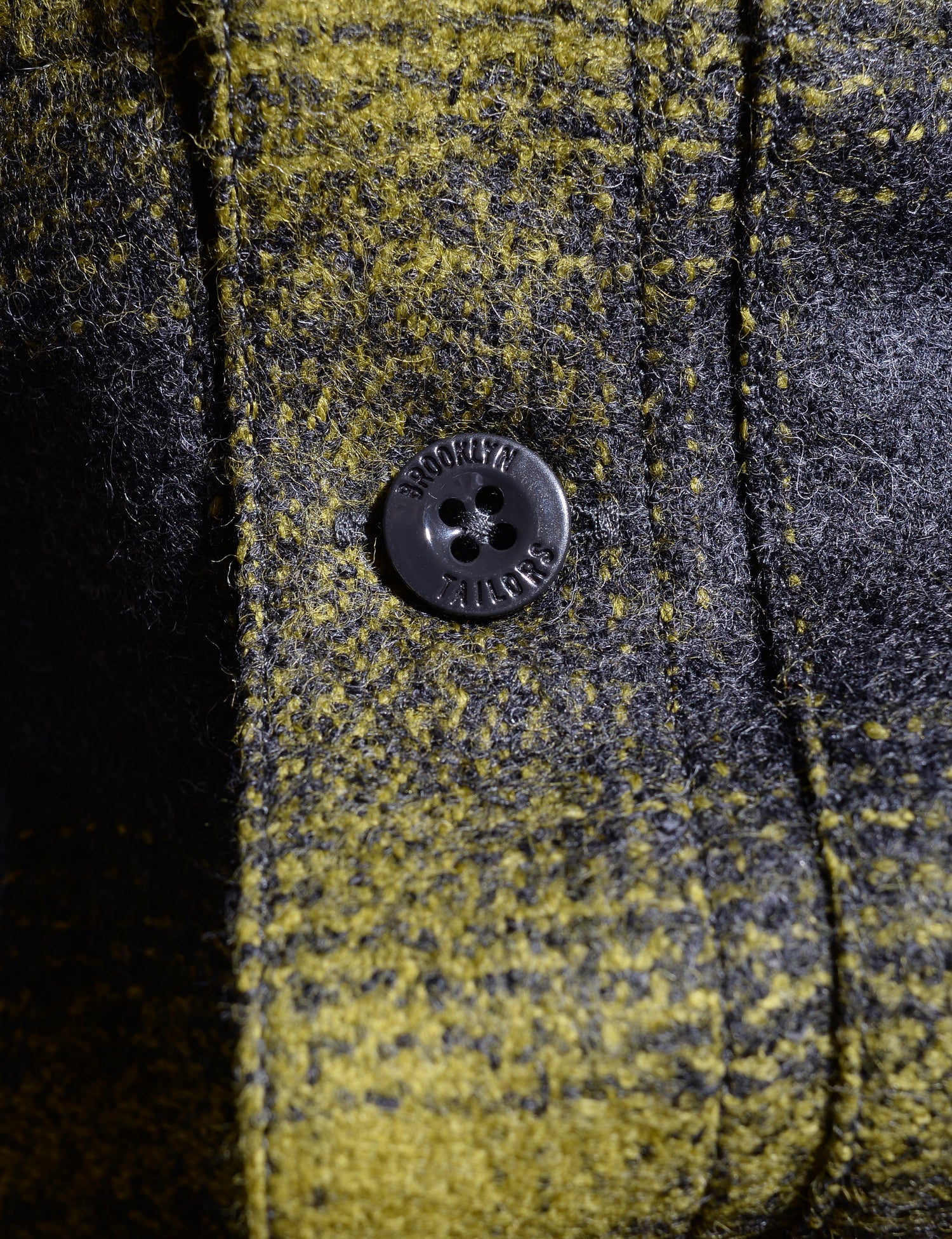 Close up of fabric and button on Brooklyn Tailors BKT15 Shirt Jacket in Boiled Wool Plaid - Gray & Acid Green