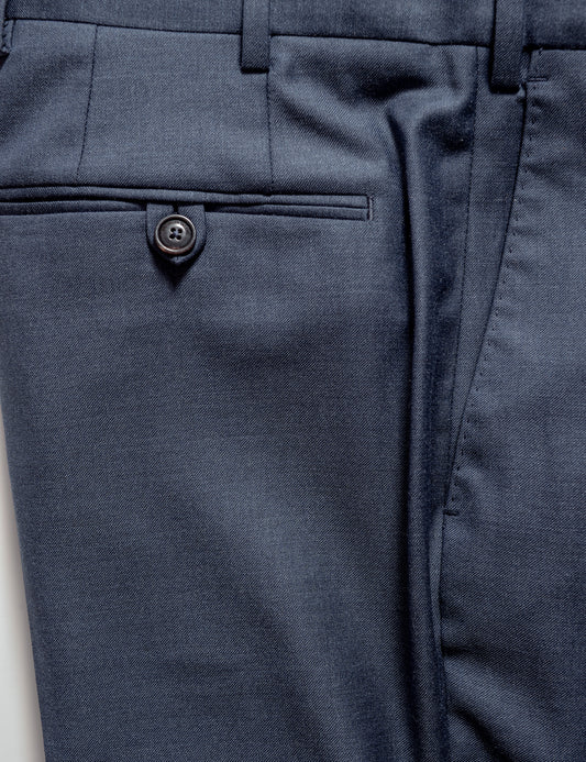 Close-up shot of BKT50 Tailored Trousers in Super 130s Heather Twill - Cool Blue showing the back pocket, button, and fabric detail